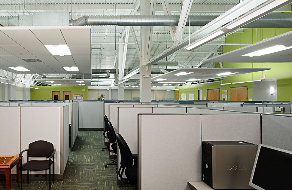 an office cubicles with chairs and computers