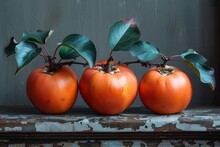 a group of orange fruit with green leaves