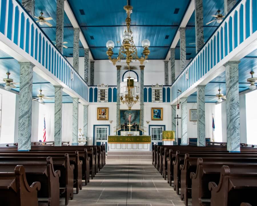 a church with benches and a chandelier