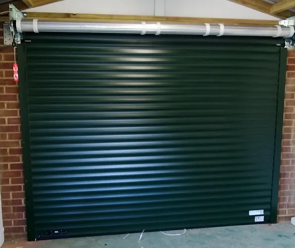 a green garage door with a pipe
