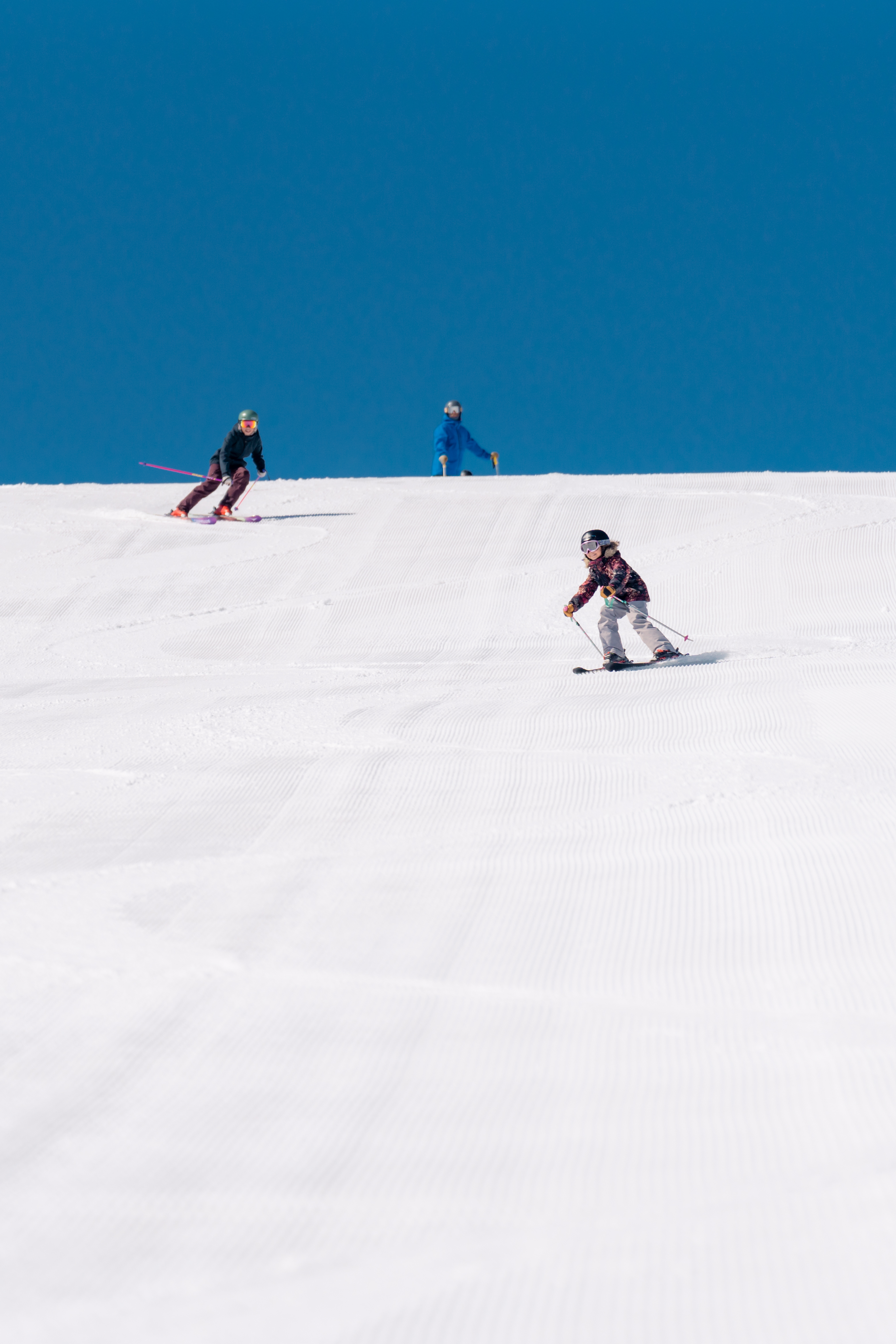 a group of people skiing down a slope