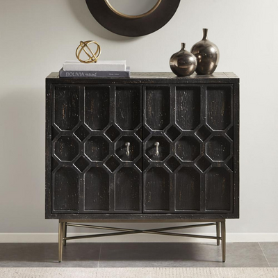 a black cabinet with a round mirror above it