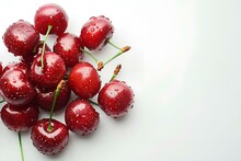 a group of cherries on a white surface