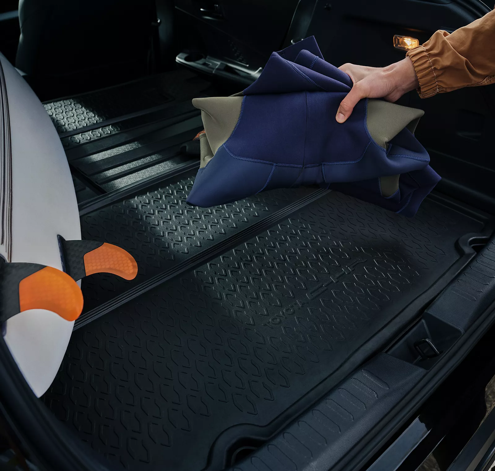 a person holding a towel in the trunk of a car