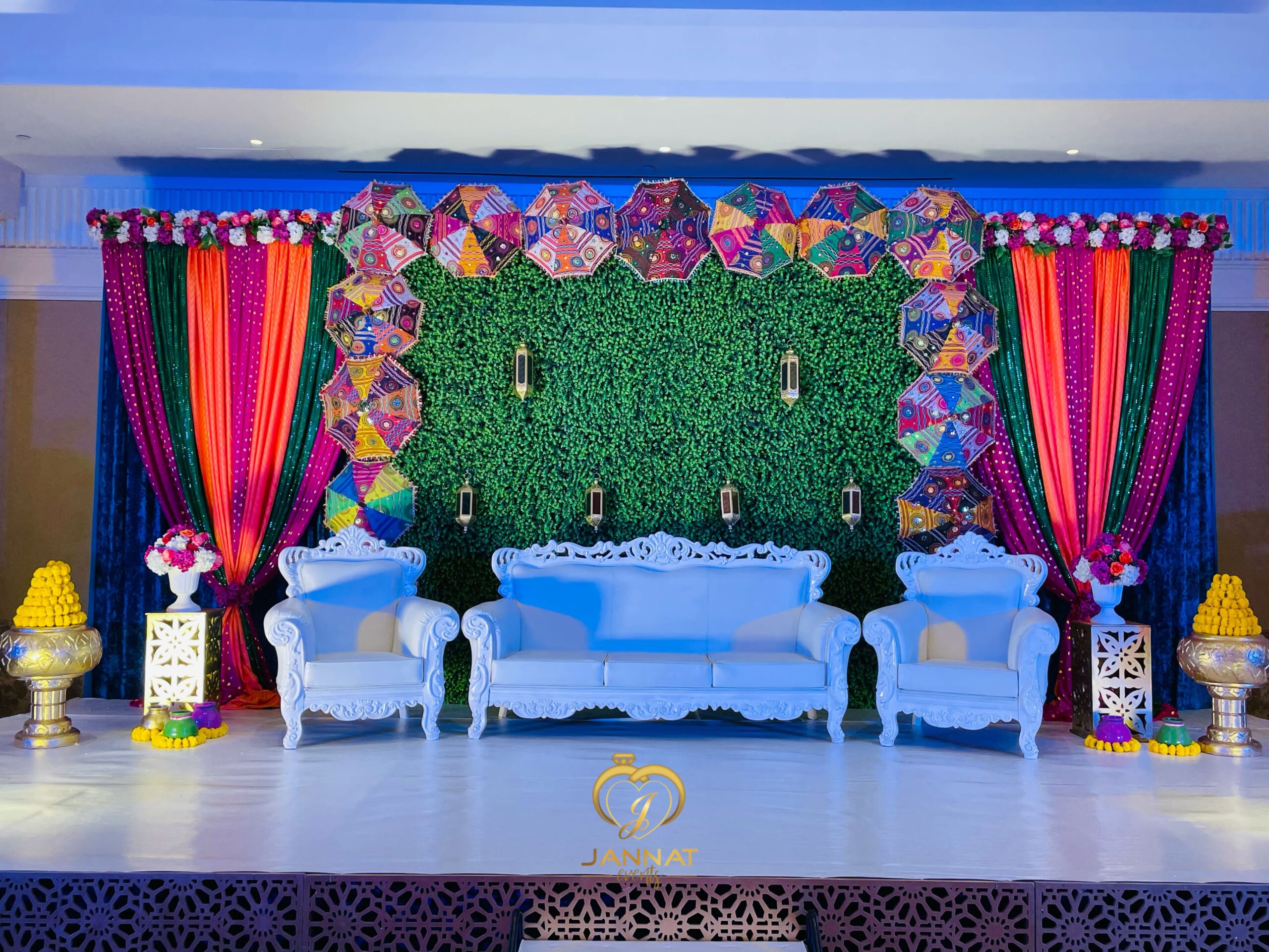 a stage with a white couch and colorful curtains