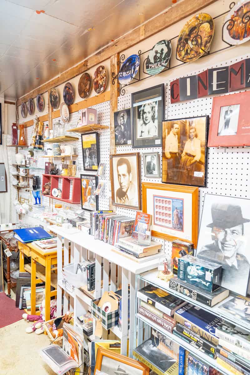 a room with a variety of objects and pictures on the wall