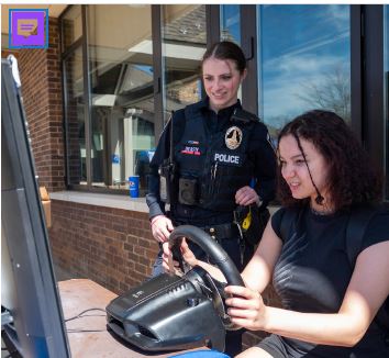 a woman sitting in front of a police officer