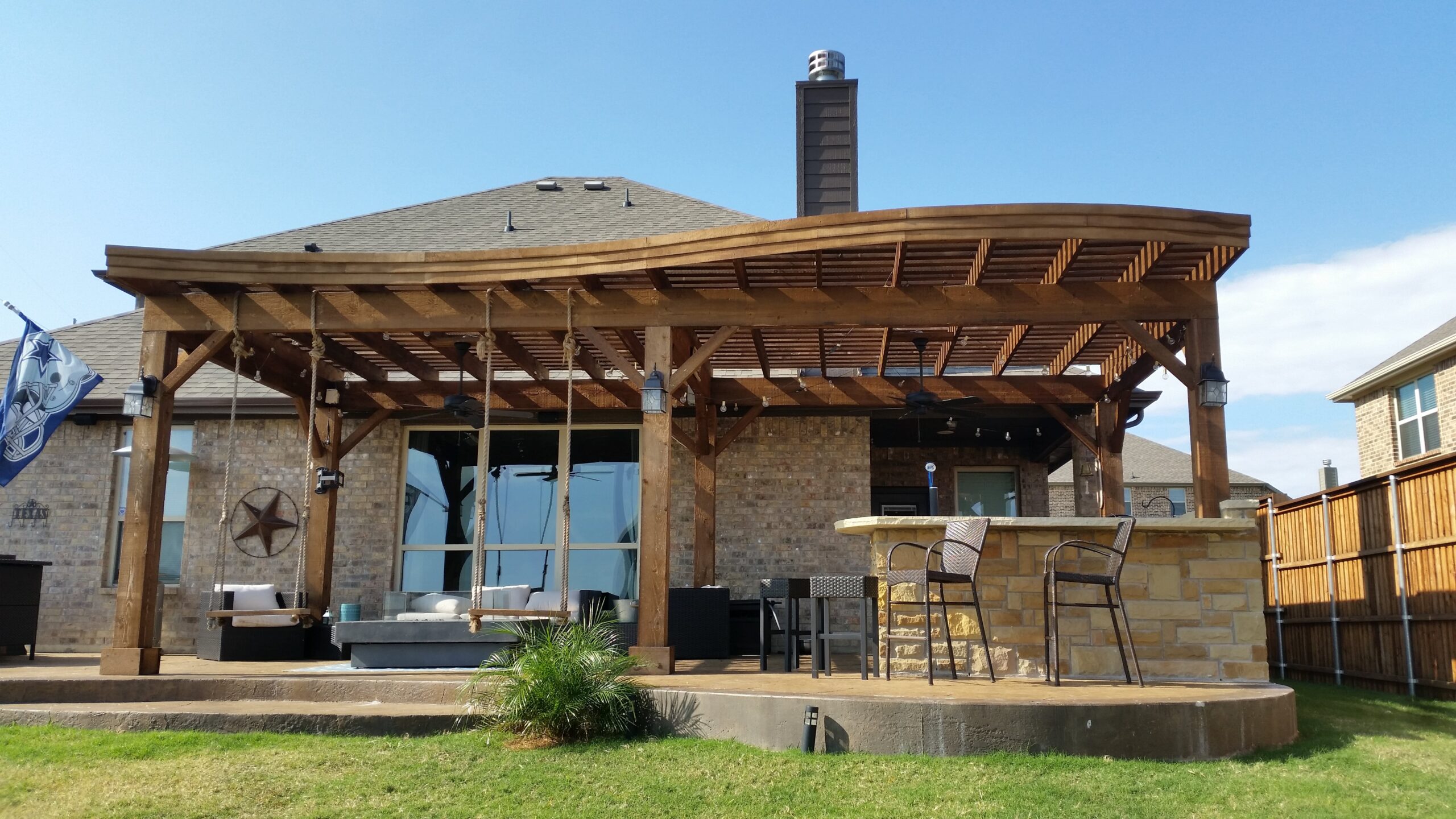 a patio with a bar and chairs