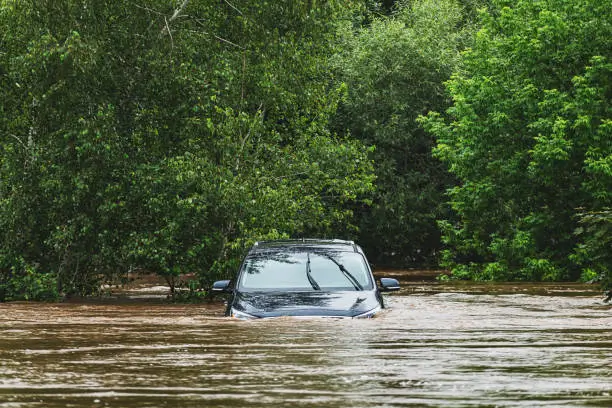 a car driving through a flooded area