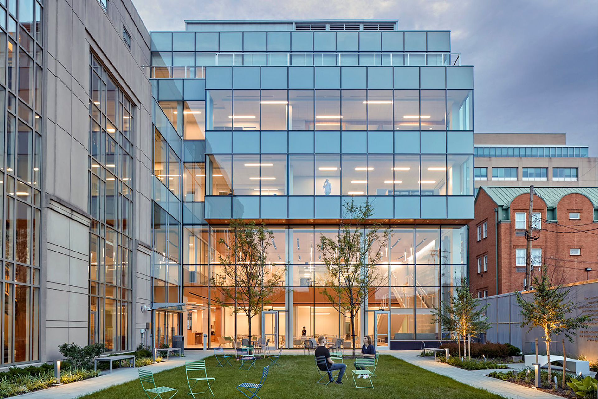 a building with glass walls and a lawn