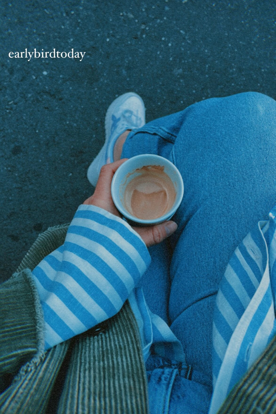 a person holding a cup of coffee