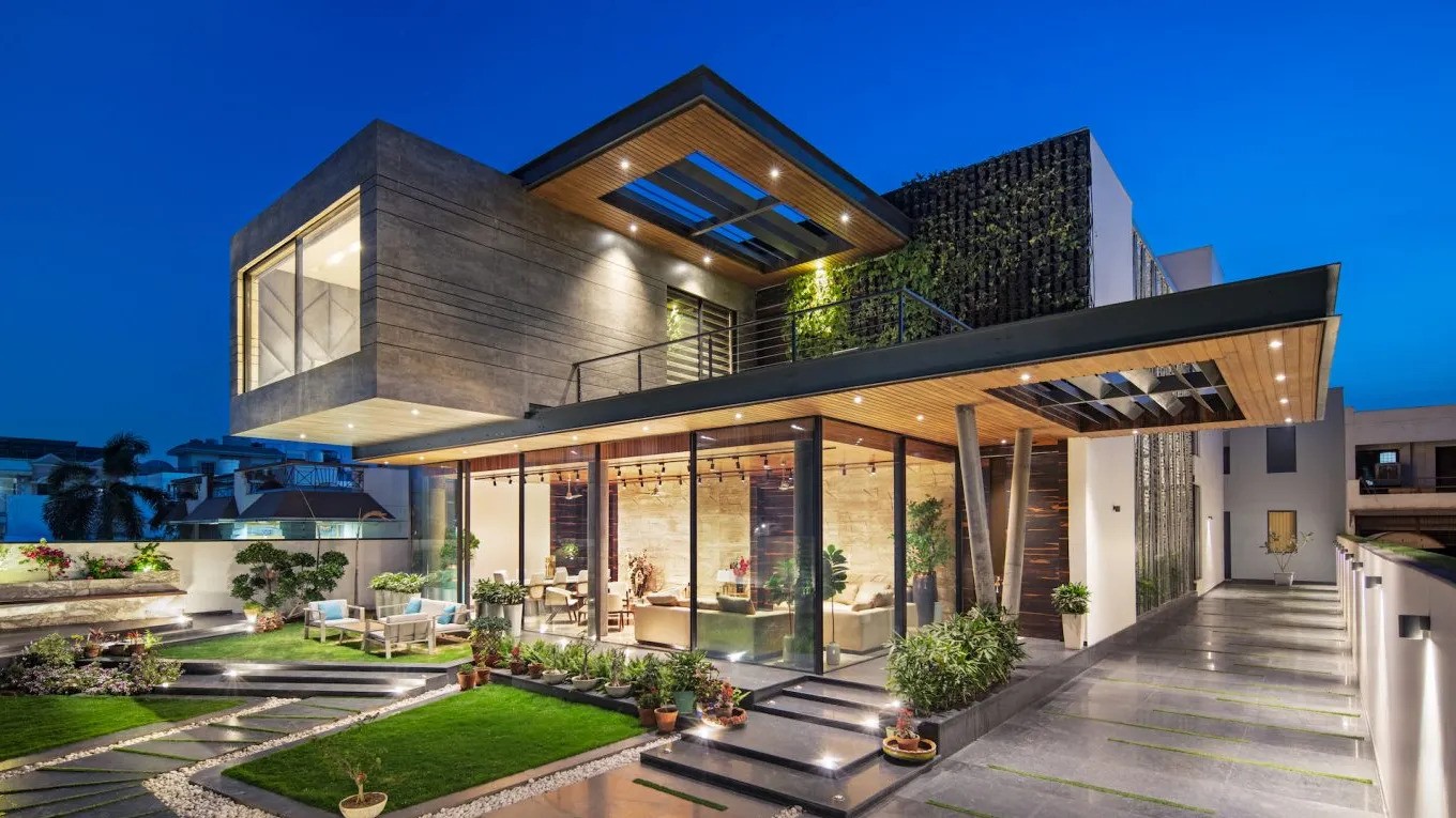 a house with a glass wall and a patio