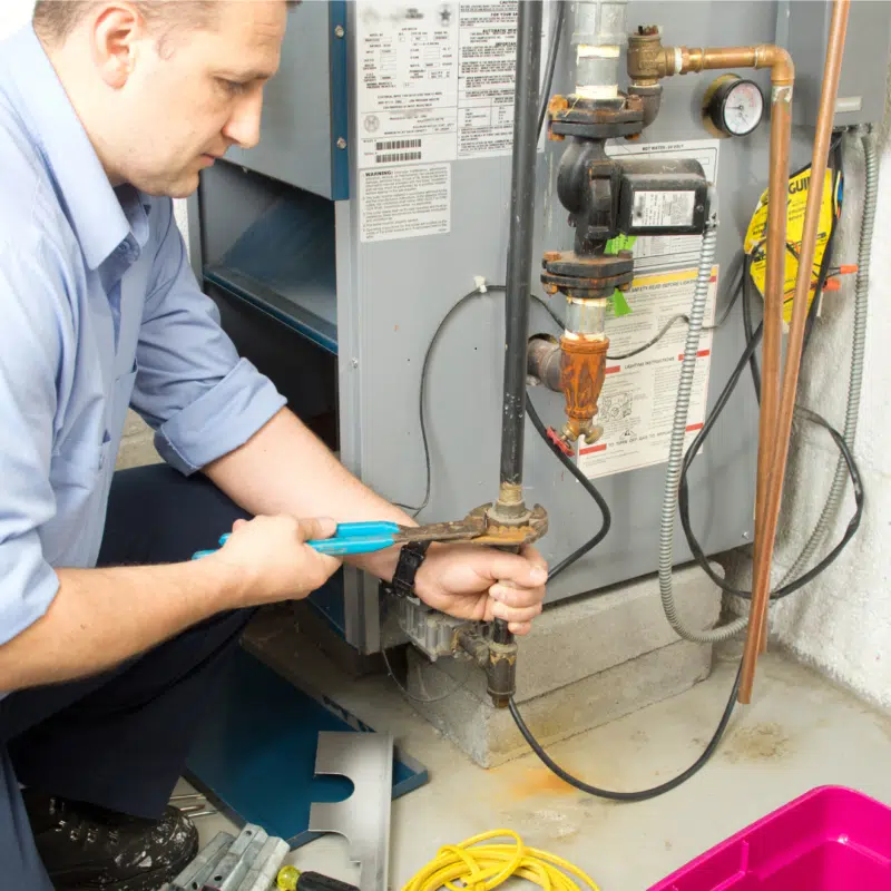 a man working on a gas boiler