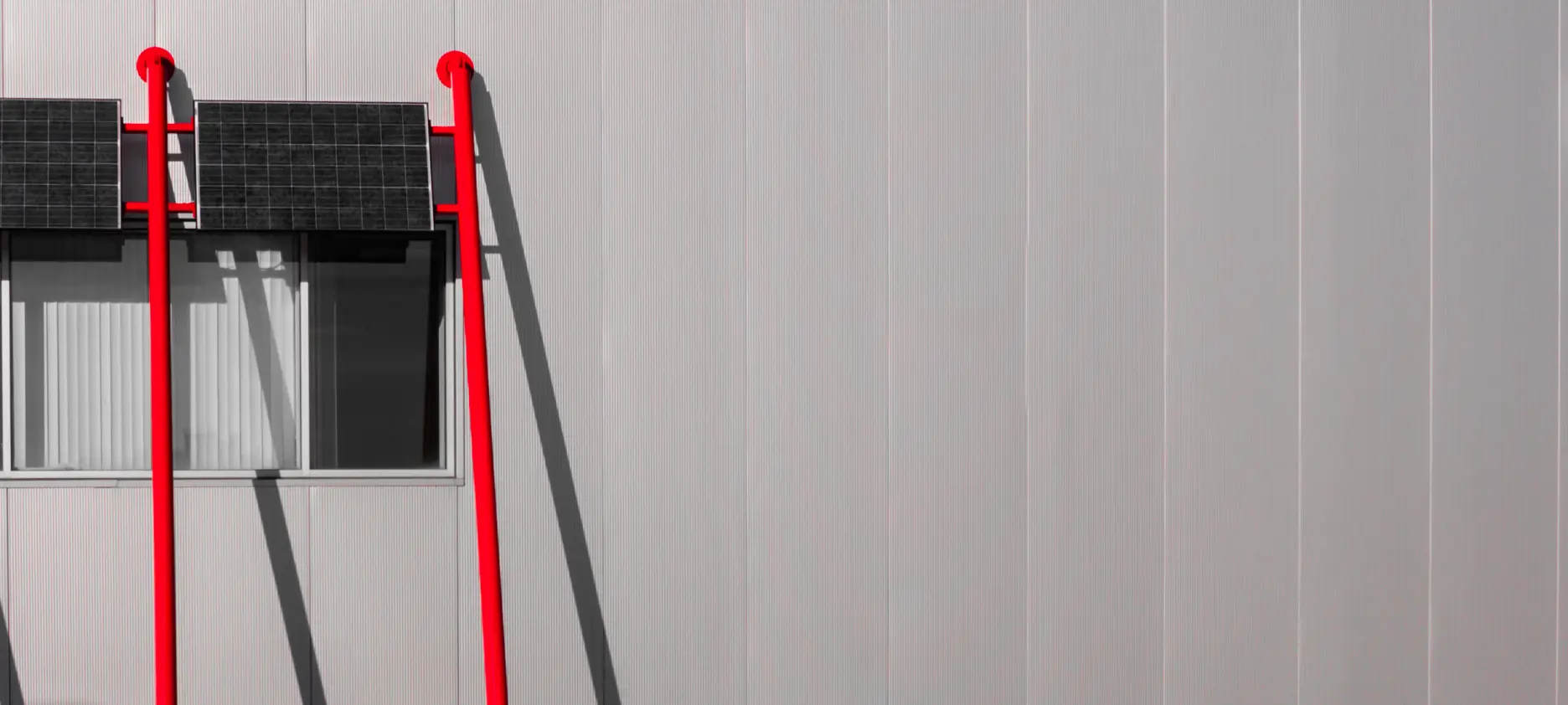 a red ladder on a grey wall