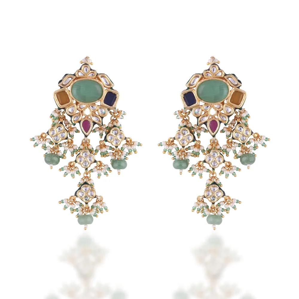 a pair of earrings with gemstones