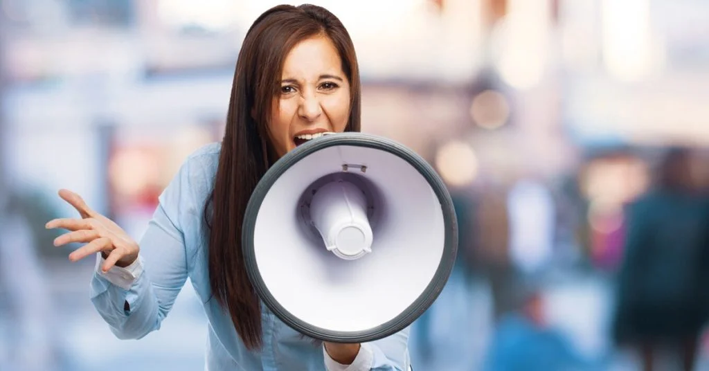 a woman yelling into a megaphone