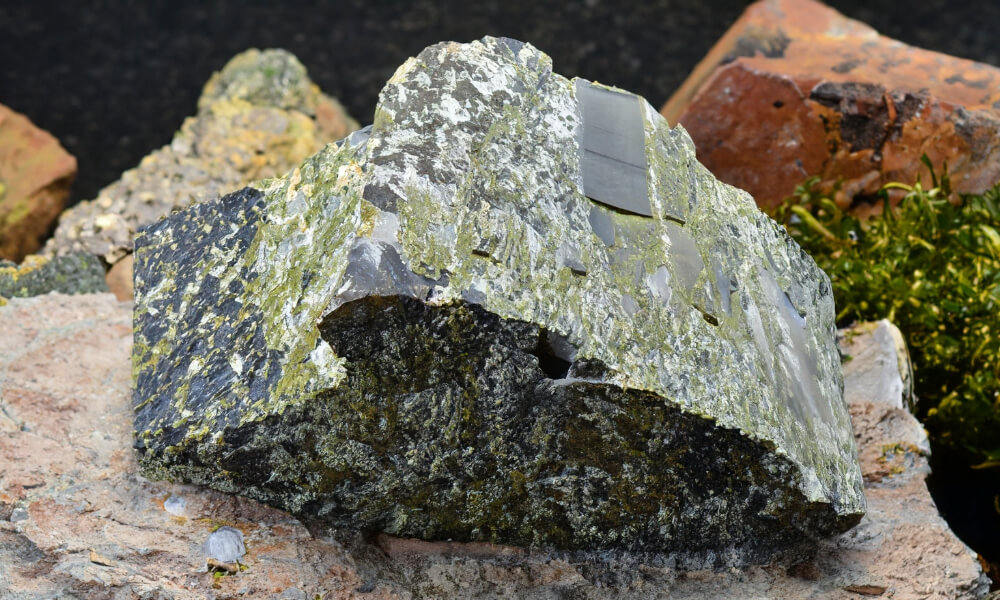 a large rock with green moss