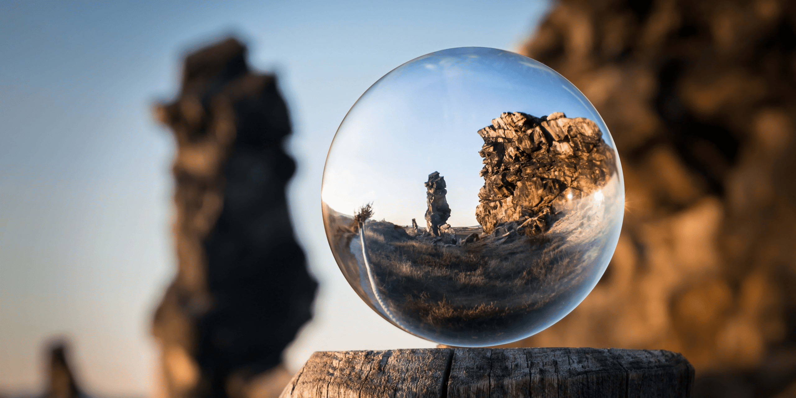 a glass ball with a reflection of a rocky landscape