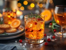 a glass of drink with ice and oranges