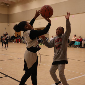 a boy and girl playing basketball