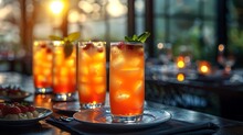 a group of glasses with ice and fruit on a table