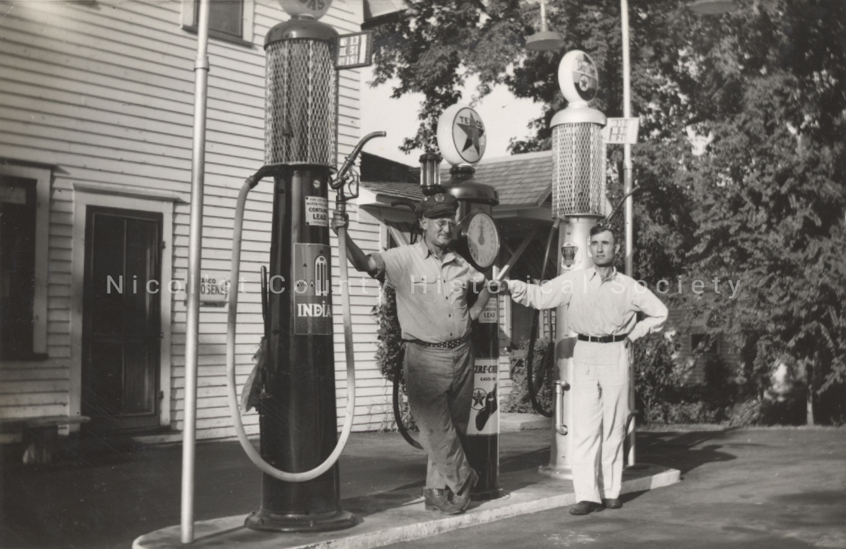 a man standing next to a gas pump