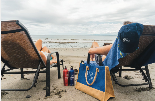 a group of people sitting in chairs on a beach