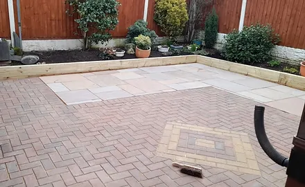 a brick patio with a brush on it