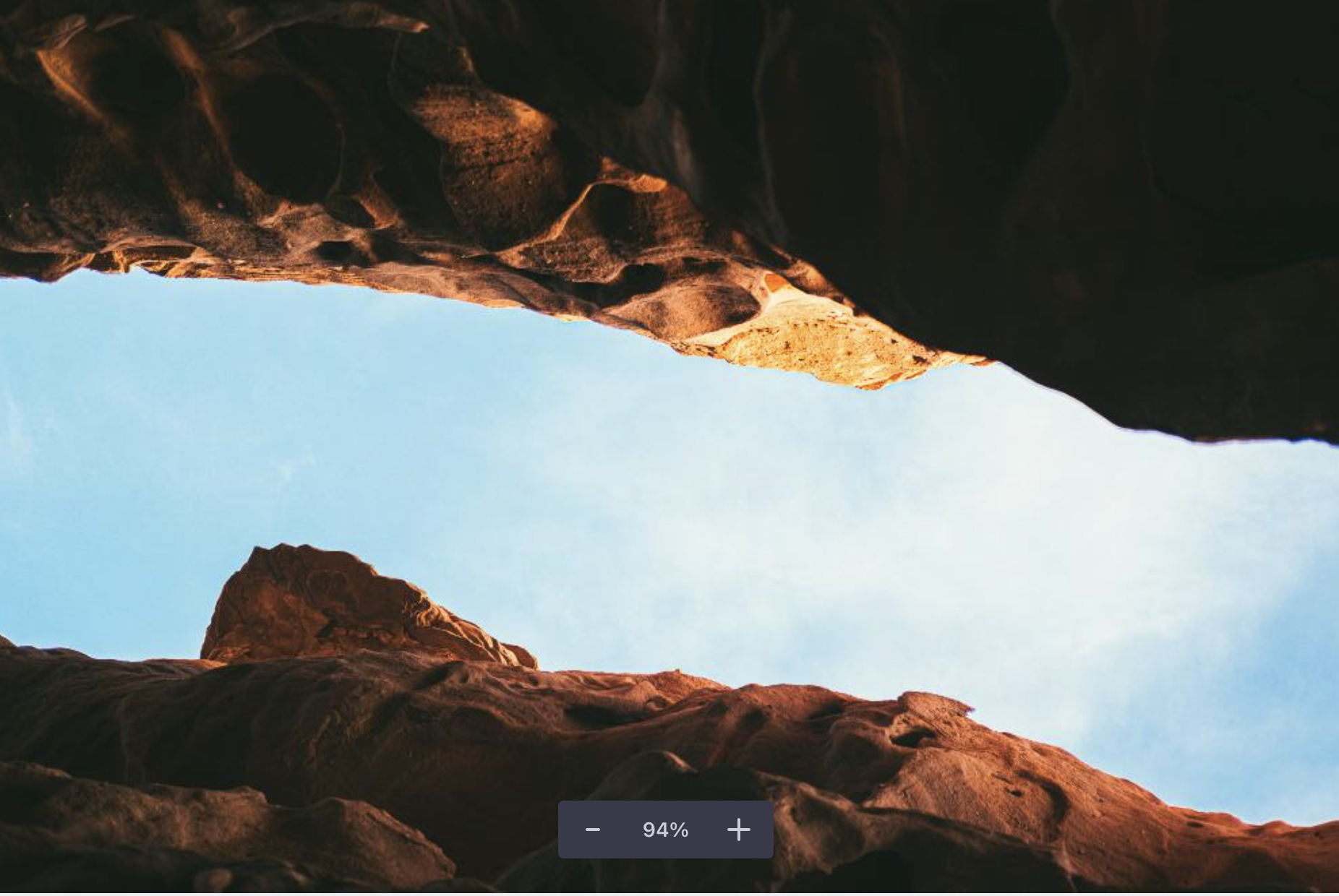 a view looking up at a rock formation