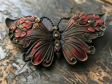 a butterfly shaped brooch on a marble surface