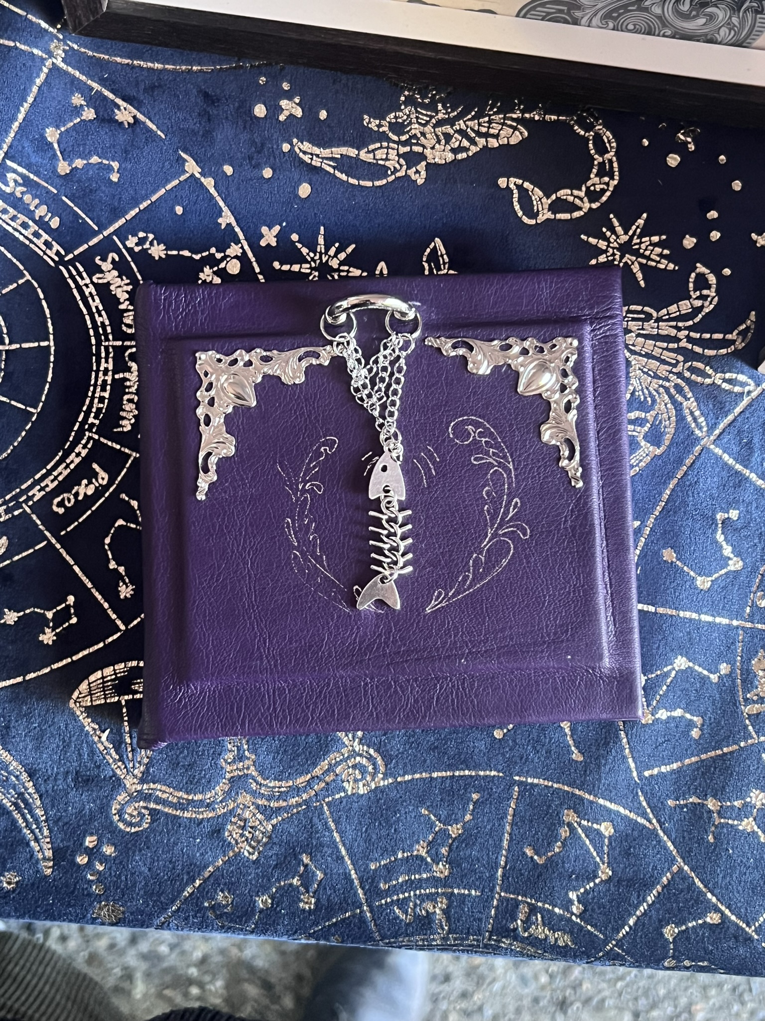 a purple book with a silver key chain on it