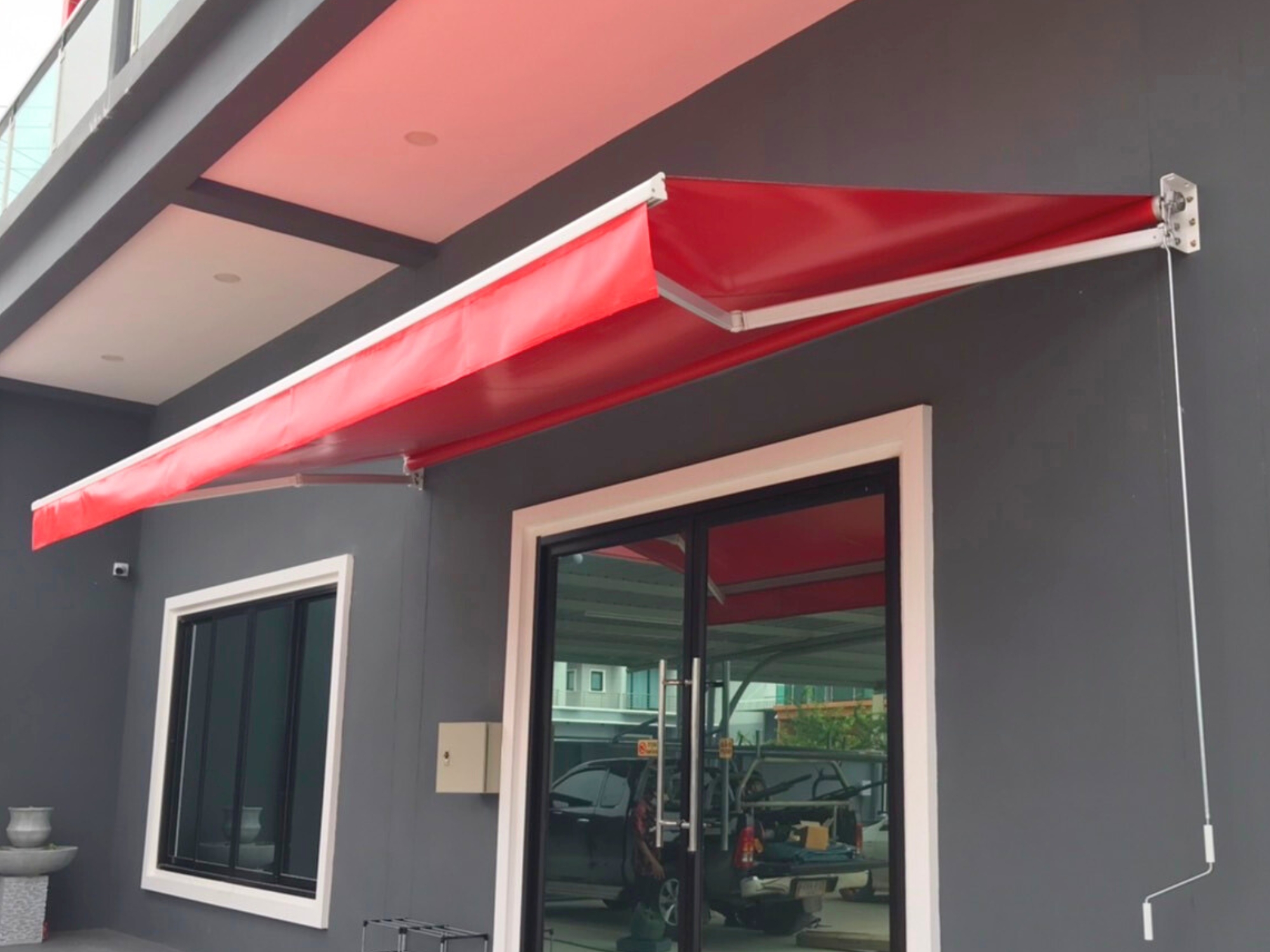 a red awning over a glass door