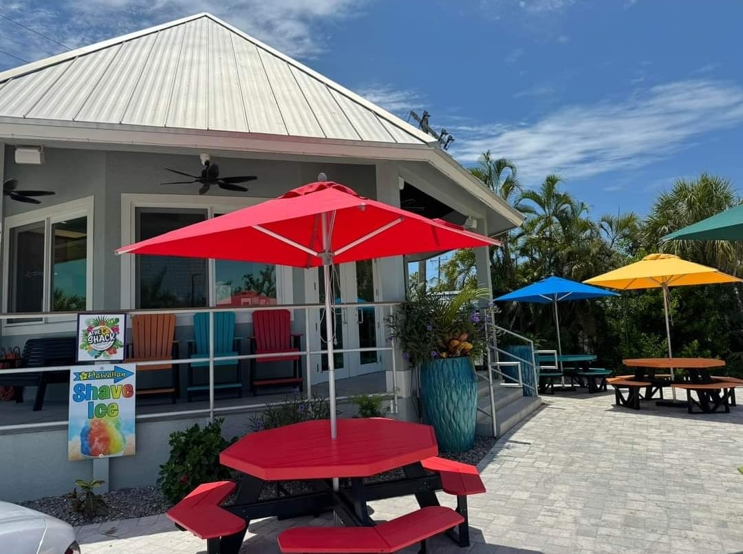 a red table and umbrellas outside of a building