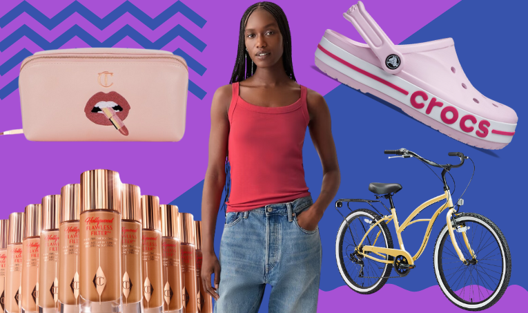 a woman standing next to a bicycle and a purse