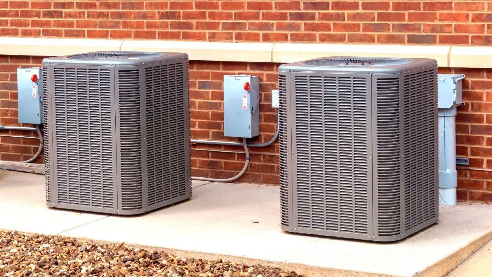 a couple of gray air conditioning units