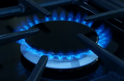 a blue flame on a stove
