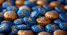 a pile of blue and gold bottle caps