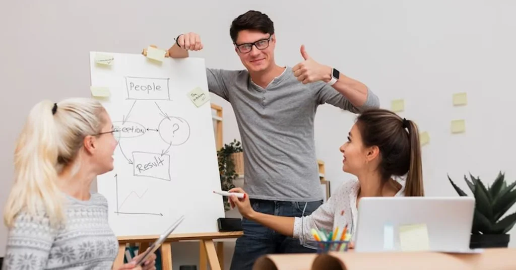a man and woman holding up a whiteboard