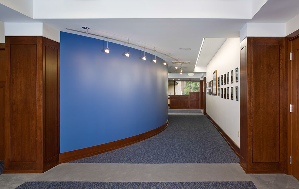 a hallway with blue walls and a blue carpet