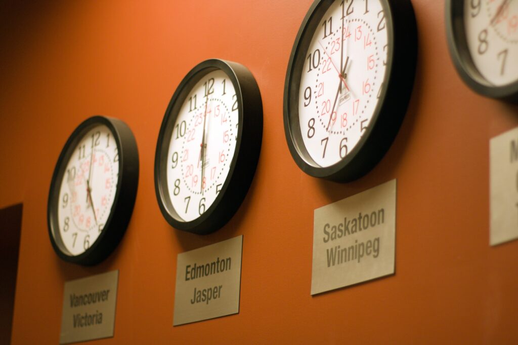 a row of clocks on a wall