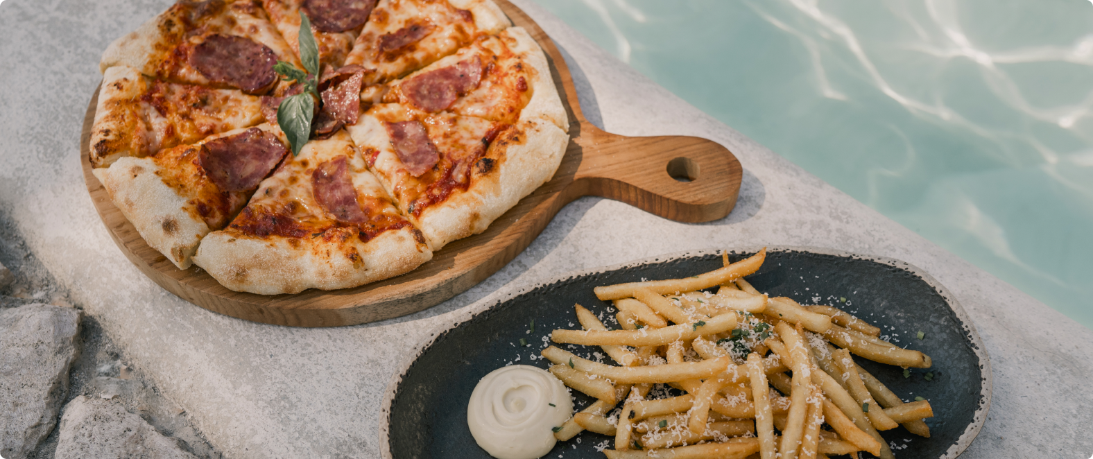 a pizza and fries on a plate