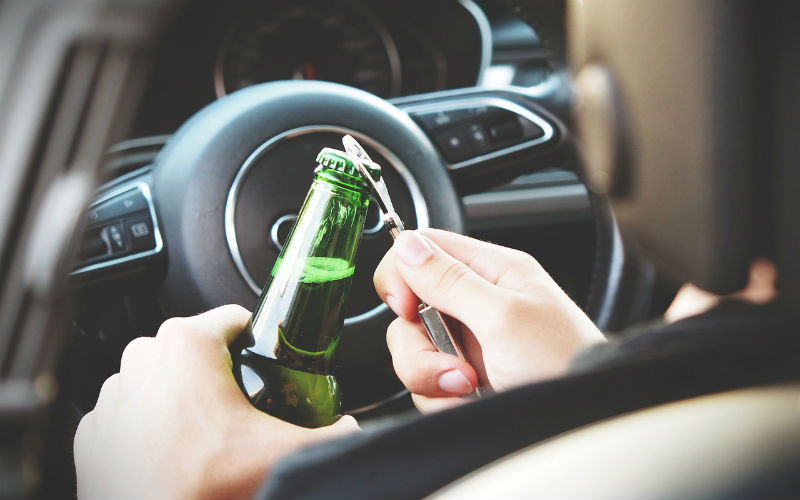 a person holding a bottle of beer