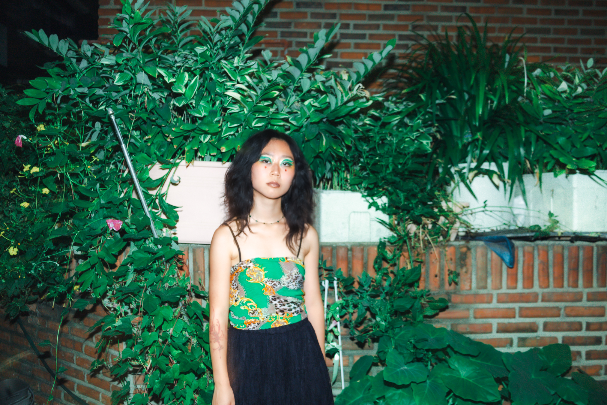 a woman standing in front of plants