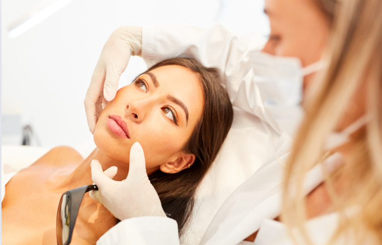 a woman lying down with a doctor in the background