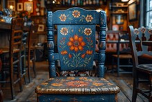 a blue chair with a flower painted on it