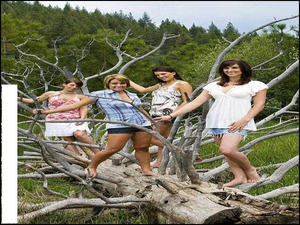 a group of women standing on a fallen tree