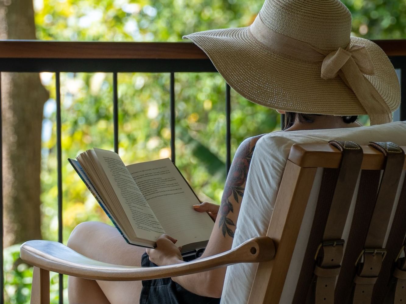 a woman sitting on a chair reading a book