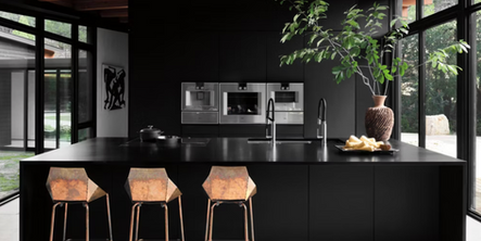 a kitchen with a black countertop and two chairs