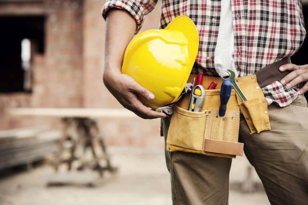 a construction worker holding a helmet