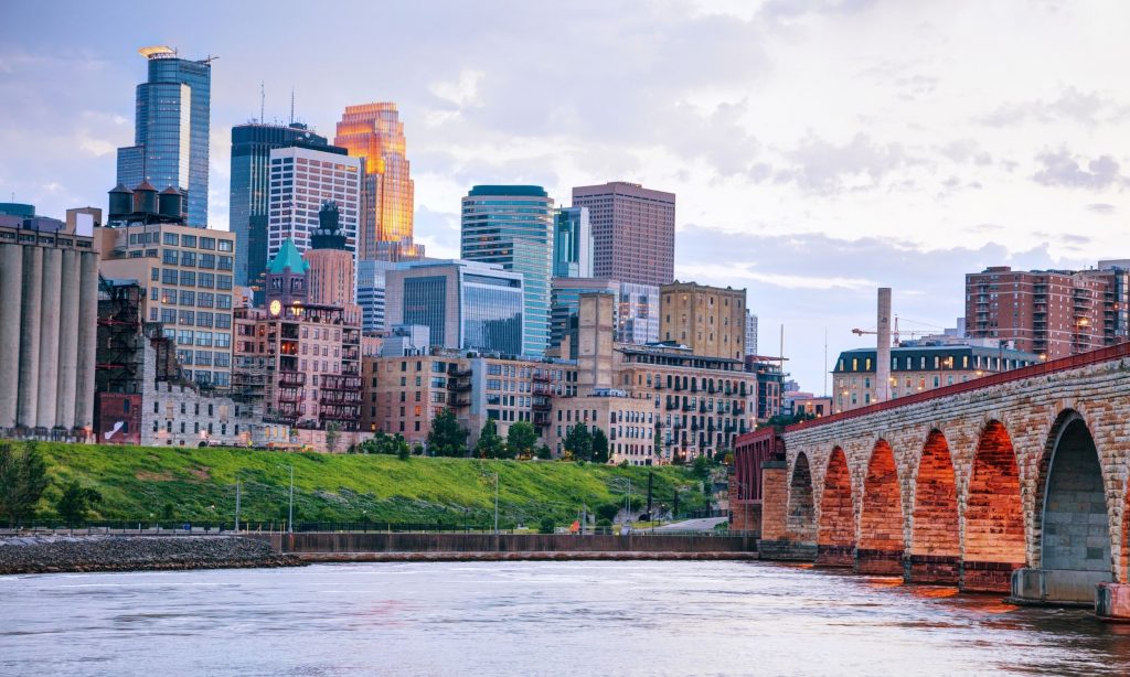 a river with a bridge and a city in the background